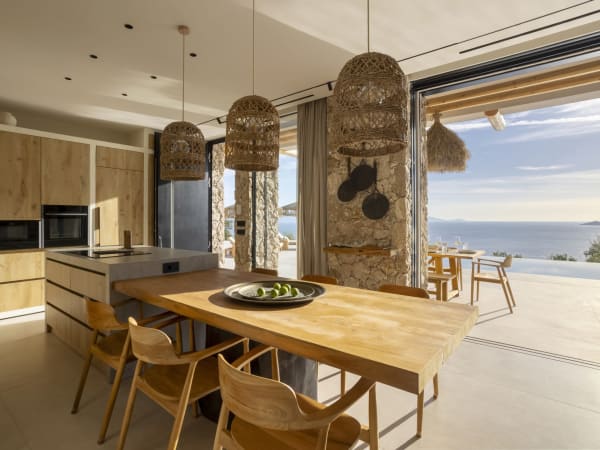 The kitchen-diner with its walls of sliding glass doors.